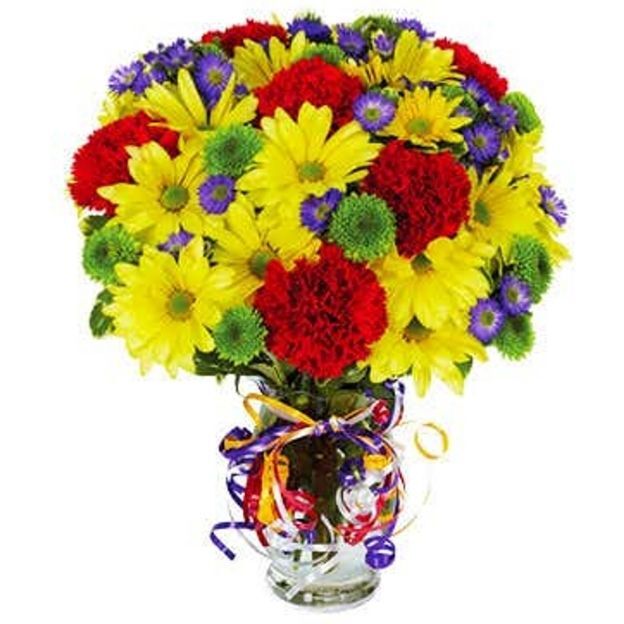 Beautiful arrangement of red carnations, yellow daisies, purple Monte Cassino, green button poms in a glass vase wrapped with colorful ribbon.